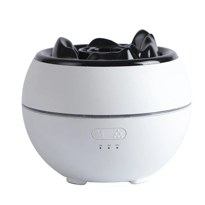 White round flame aroma diffuser humidifier with timer settings on a desk.
