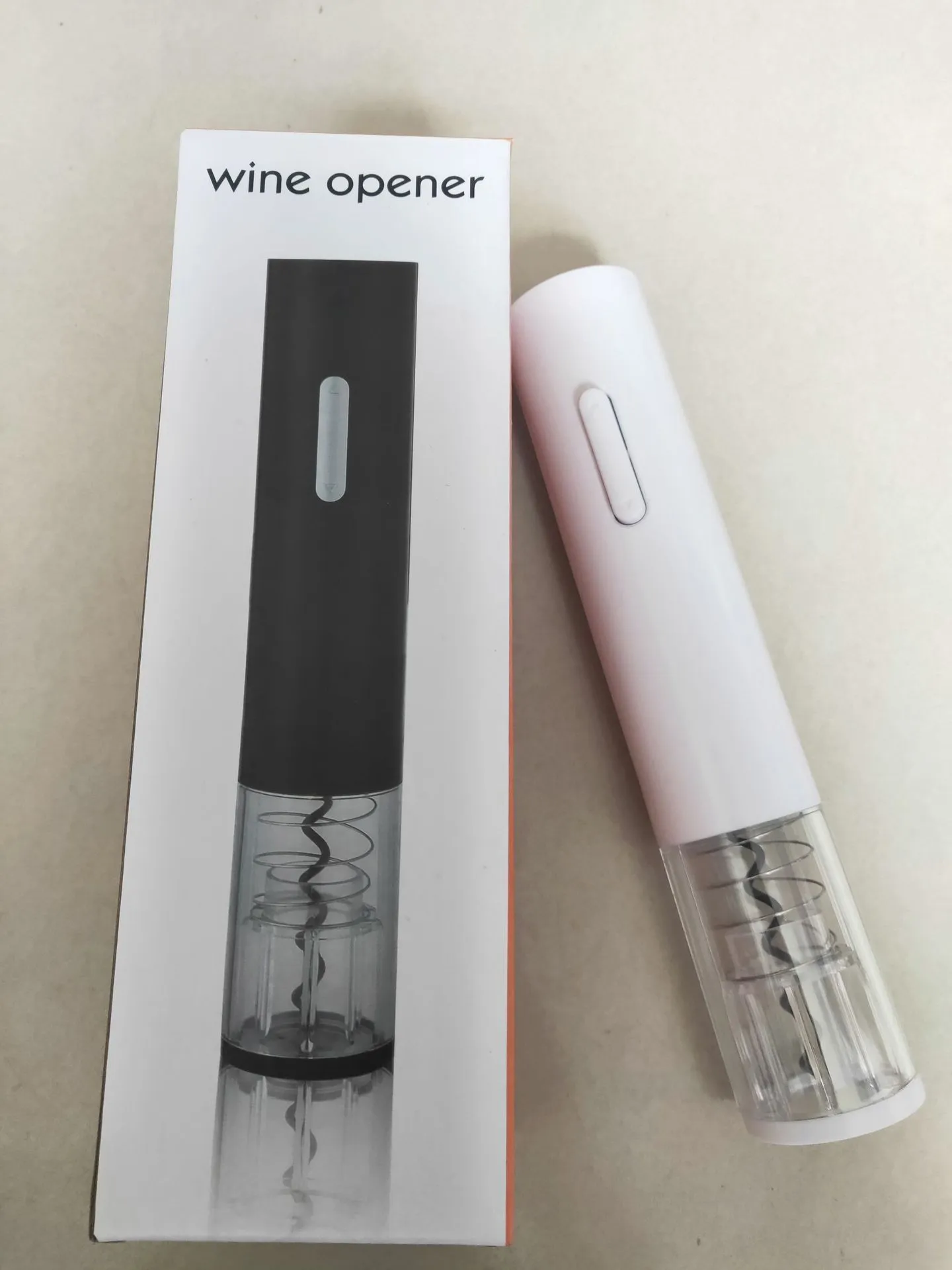 Black electric wine bottle opener with foil cutter showing automatic corkscrew mechanism