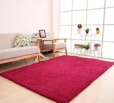 White plush lambswool rectangular area rug with non-slip dotted bottom on wooden floor