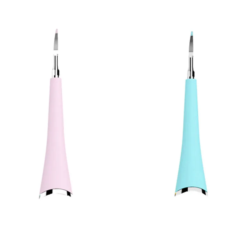Pink or blue waterproof electric toothbrush care tool for removing dental calculus on a bathroom counter.