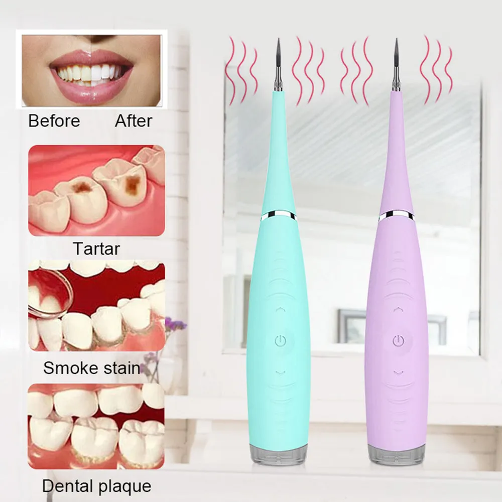 Pink or blue waterproof electric toothbrush care tool for removing dental calculus on a bathroom counter.
