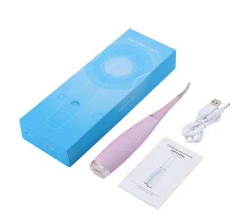 Pink or blue waterproof electric toothbrush care tool for removing dental calculus on a bathroom counter.