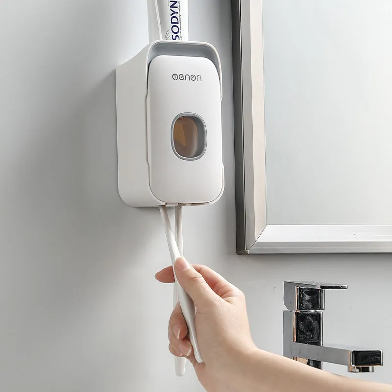 Automatic wall-mounted toothpaste dispenser in blue, grey, or pink colours