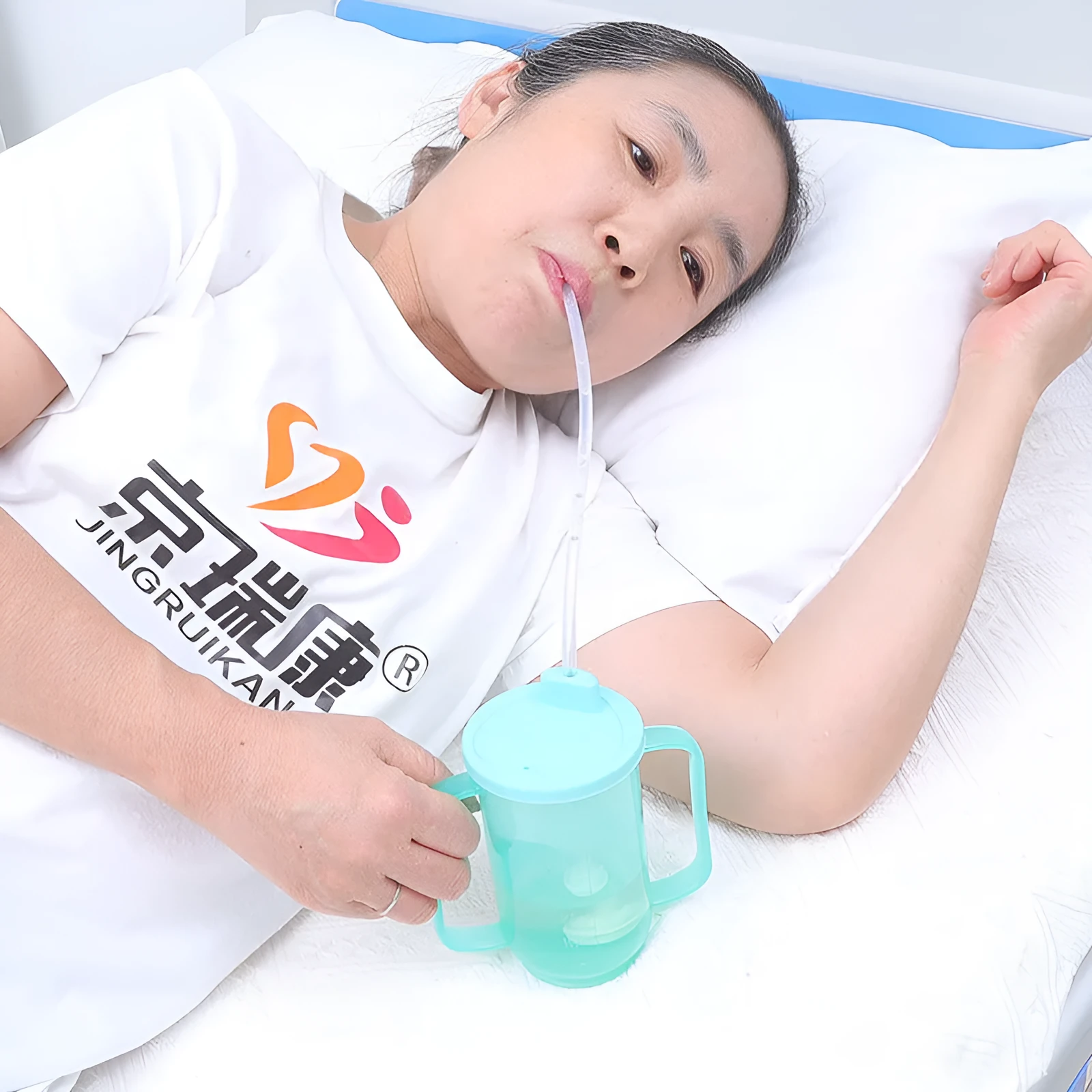 Adult oblique mouth choke proof bed drinking cup with handle and optional wrist splint.