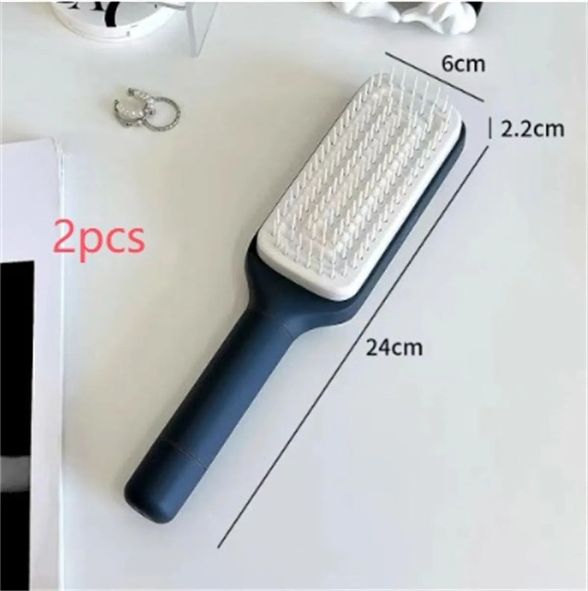 Purple and grey self-cleaning hair brushes with rotating handles and anti-static teeth.