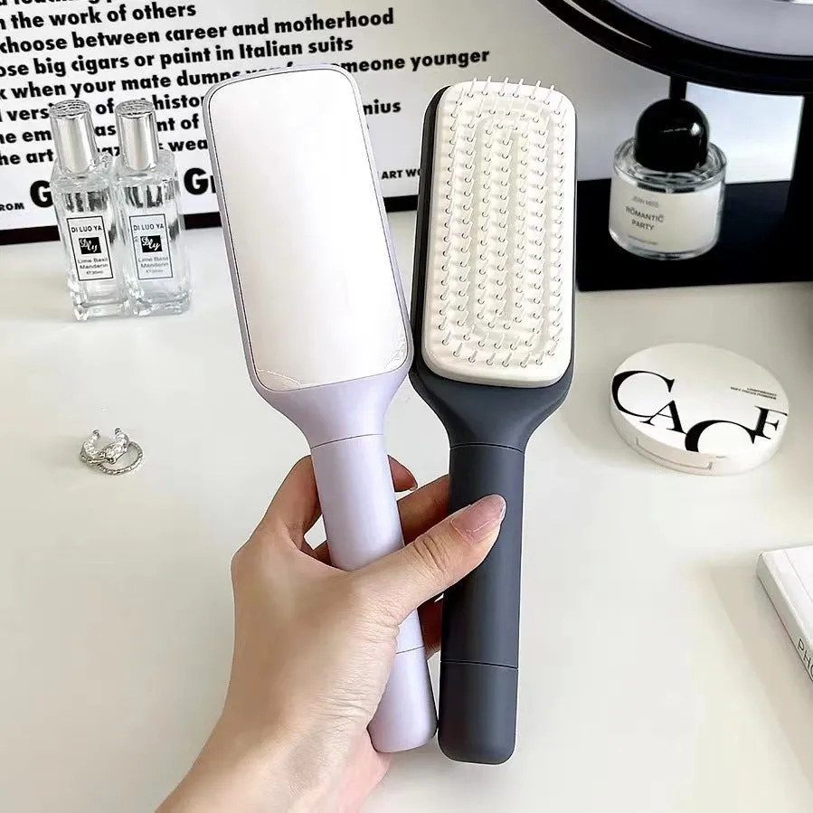 Purple and grey self-cleaning hair brushes with rotating handles and anti-static teeth.