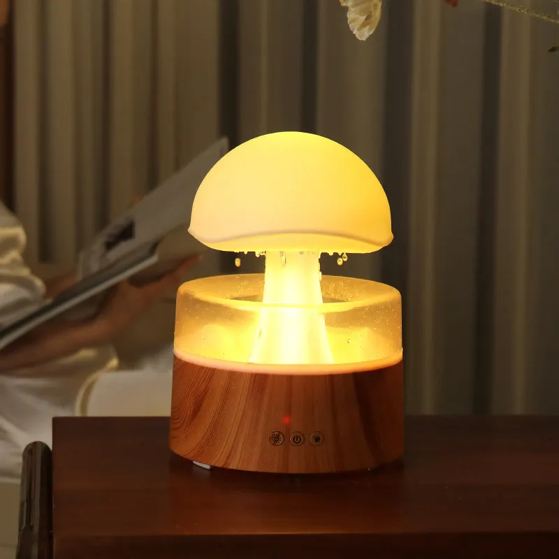 White cloud-shaped ultrasonic humidifier producing rainfall mist with colour-changing night light effects