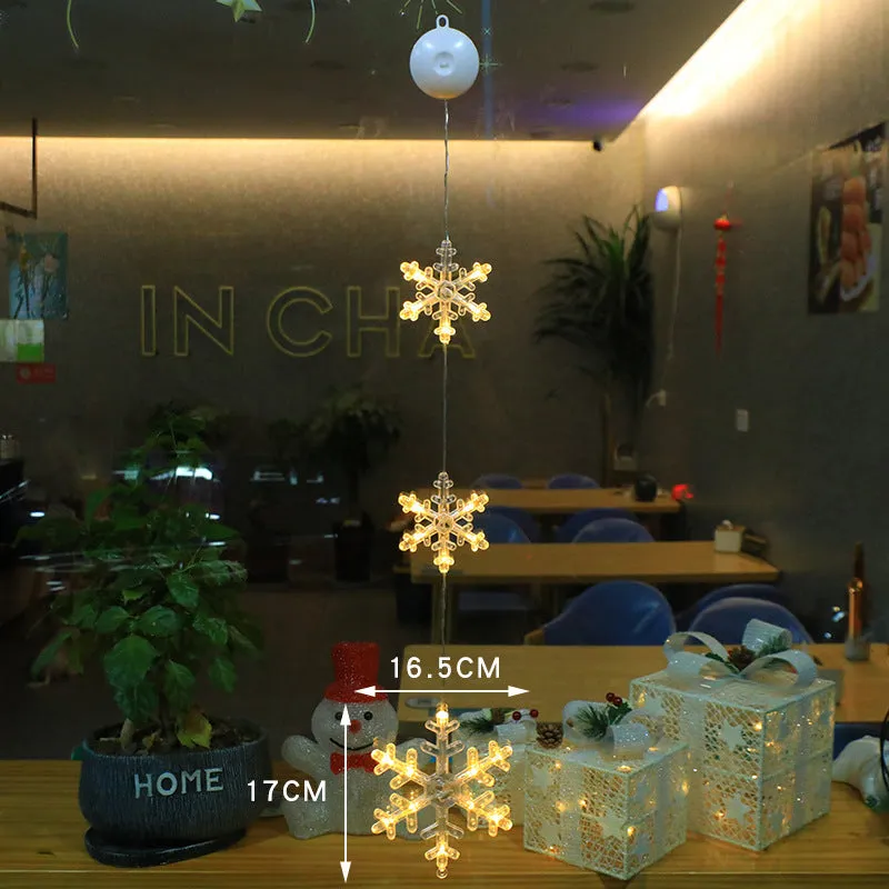 Christmas LED window light with suction cups showing deer, bell, and tree designs