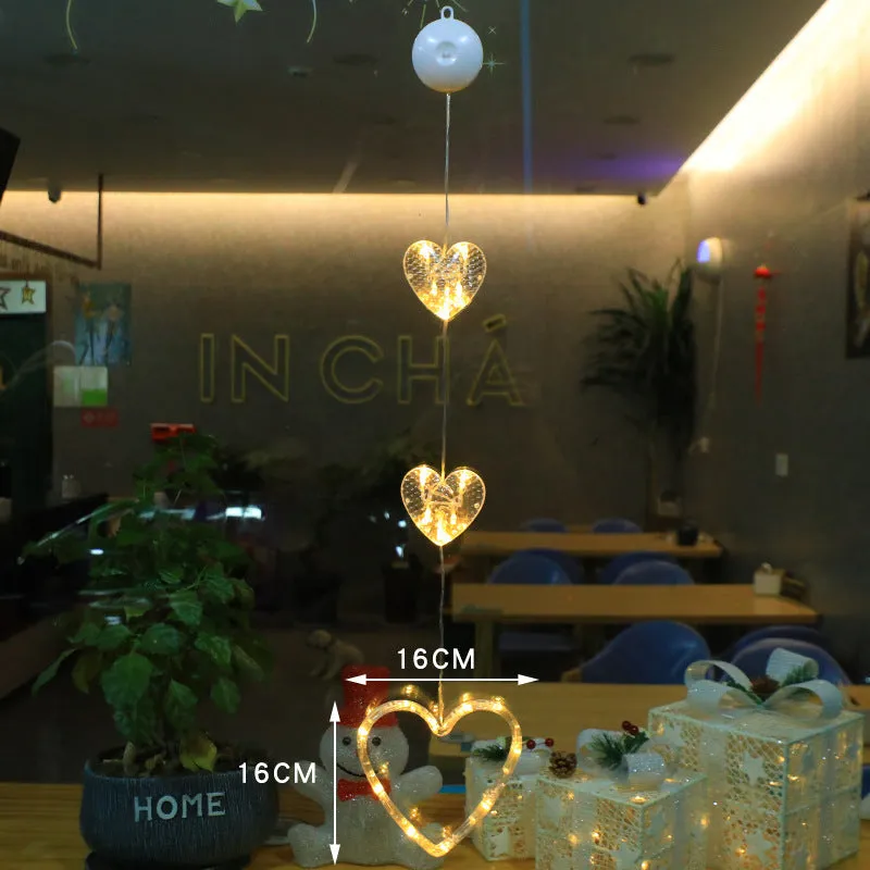 Christmas LED window light with suction cups showing deer, bell, and tree designs