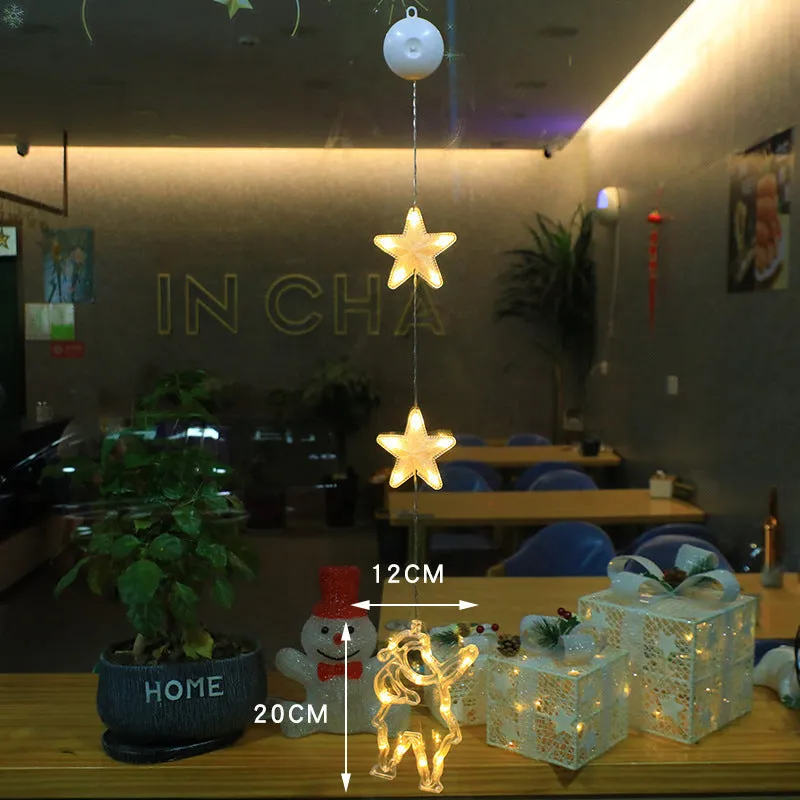 Christmas LED window light with suction cups showing deer, bell, and tree designs