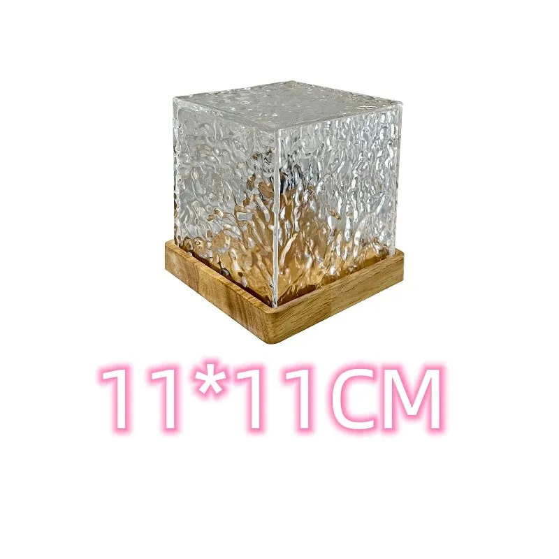 USB rechargeable crystal table lamp projecting blue water ripple light pattern on wall.