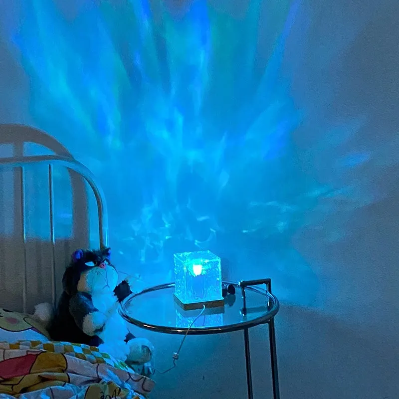USB rechargeable crystal table lamp projecting blue water ripple light pattern on wall.