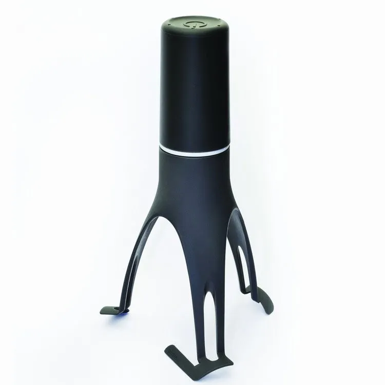 Green and grey automatic Stirr utensil for hands-free mixing in a cooking pot.