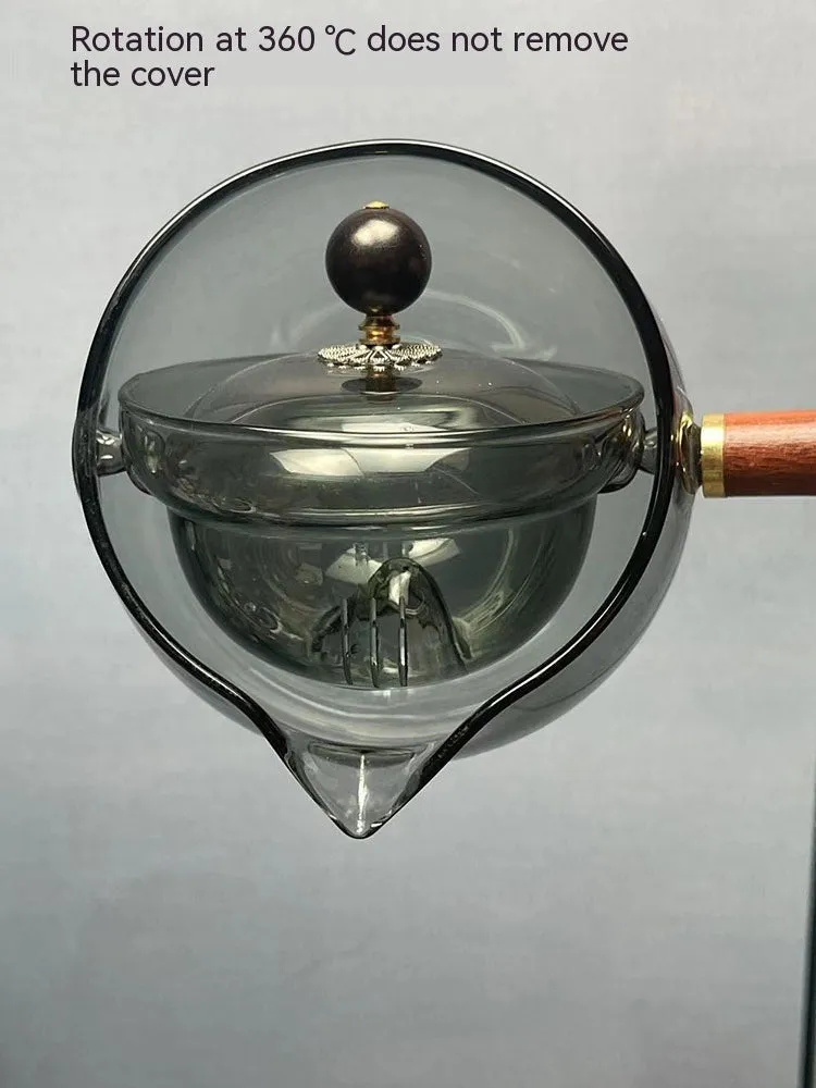 Transparent rotating glass teapot with wooden handle and integrated tea infuser