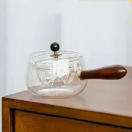Transparent rotating glass teapot with wooden handle and integrated tea infuser