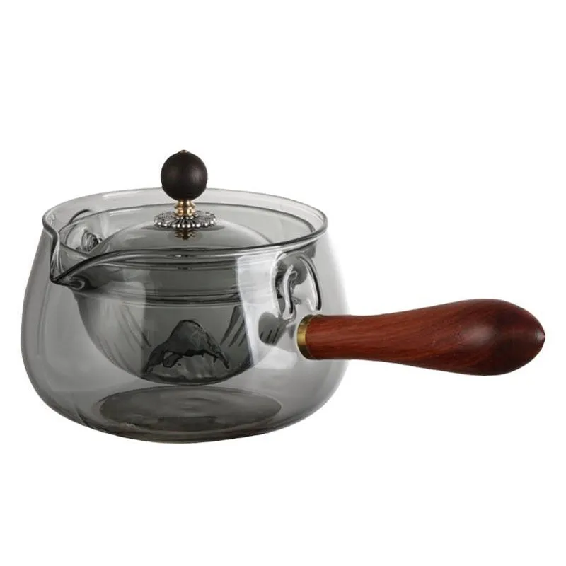 Transparent rotating glass teapot with wooden handle and integrated tea infuser