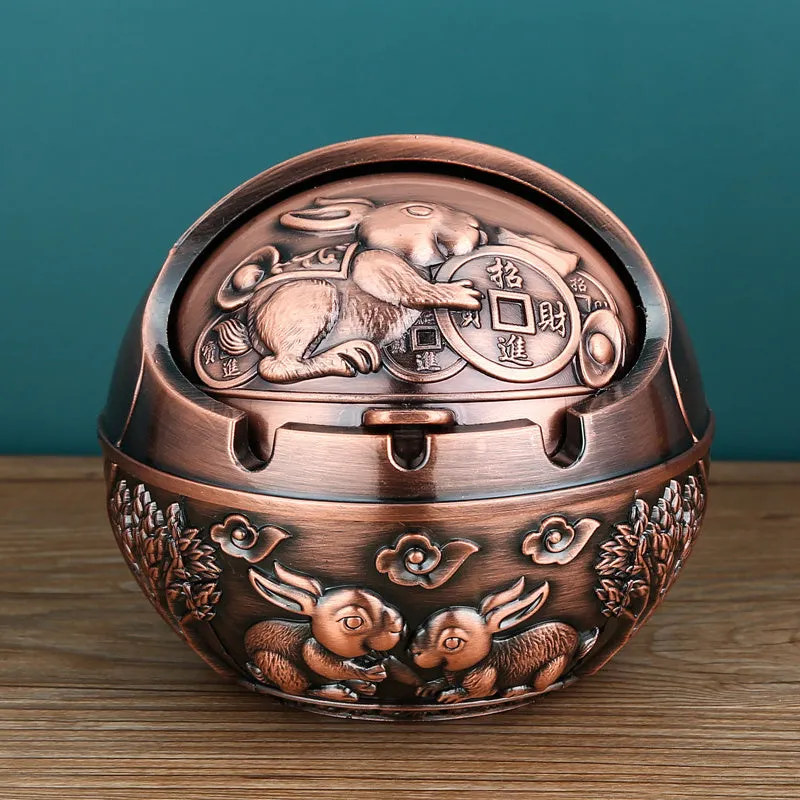 Bronze alloy ashtray with decorative fortune tree design and smoke extinguishing slot.