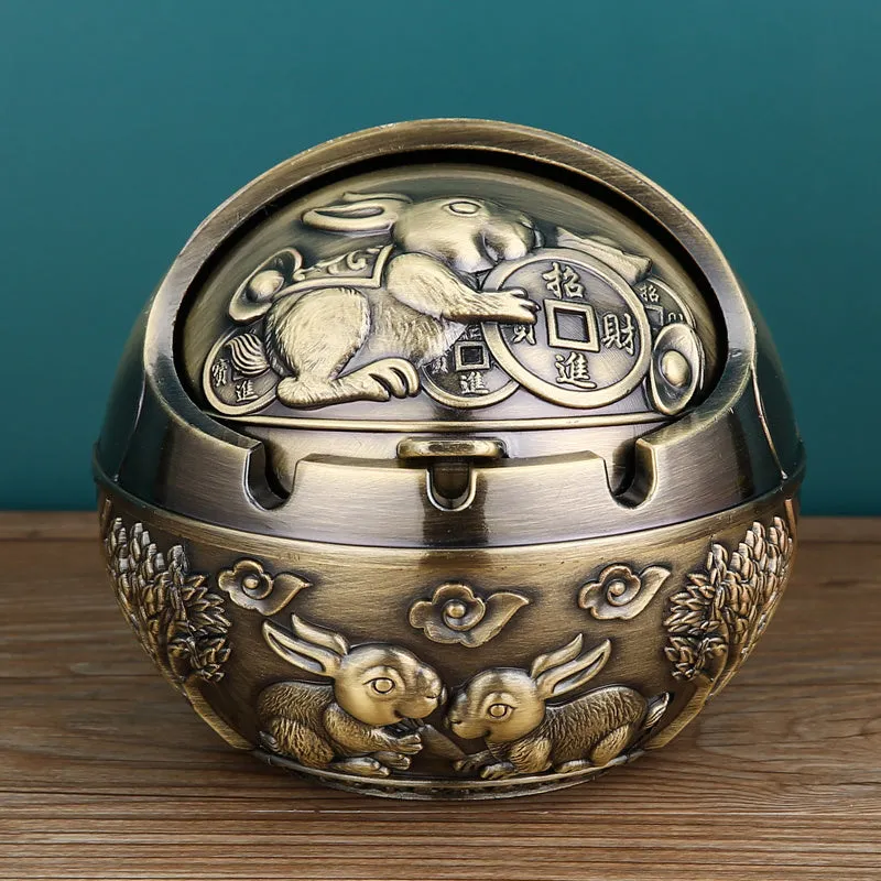 Bronze alloy ashtray with decorative fortune tree design and smoke extinguishing slot.