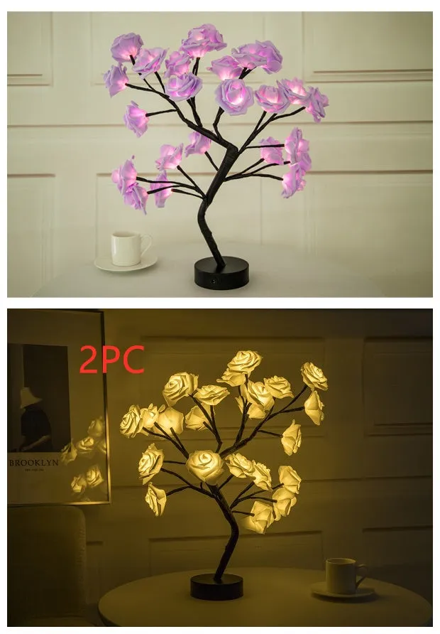 White and red rose flower shaped USB battery LED table lamp with warm white light on a table.