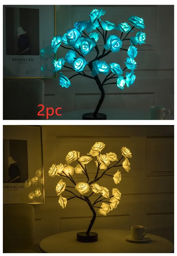 White and red rose flower shaped USB battery LED table lamp with warm white light on a table.