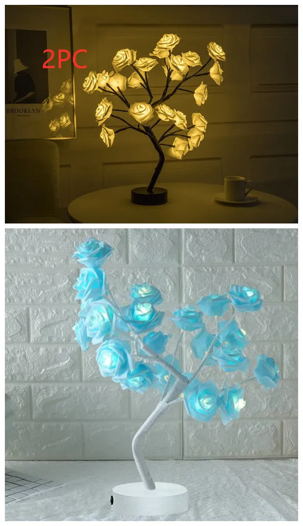 White and red rose flower shaped USB battery LED table lamp with warm white light on a table.
