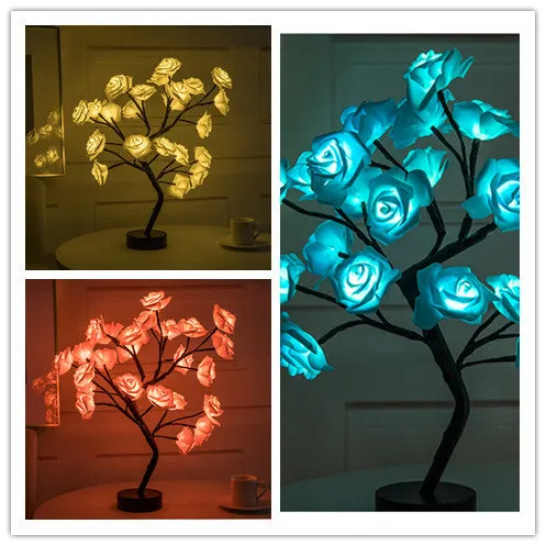 White and red rose flower shaped USB battery LED table lamp with warm white light on a table.