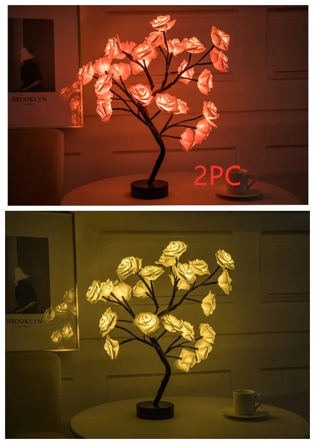 White and red rose flower shaped USB battery LED table lamp with warm white light on a table.