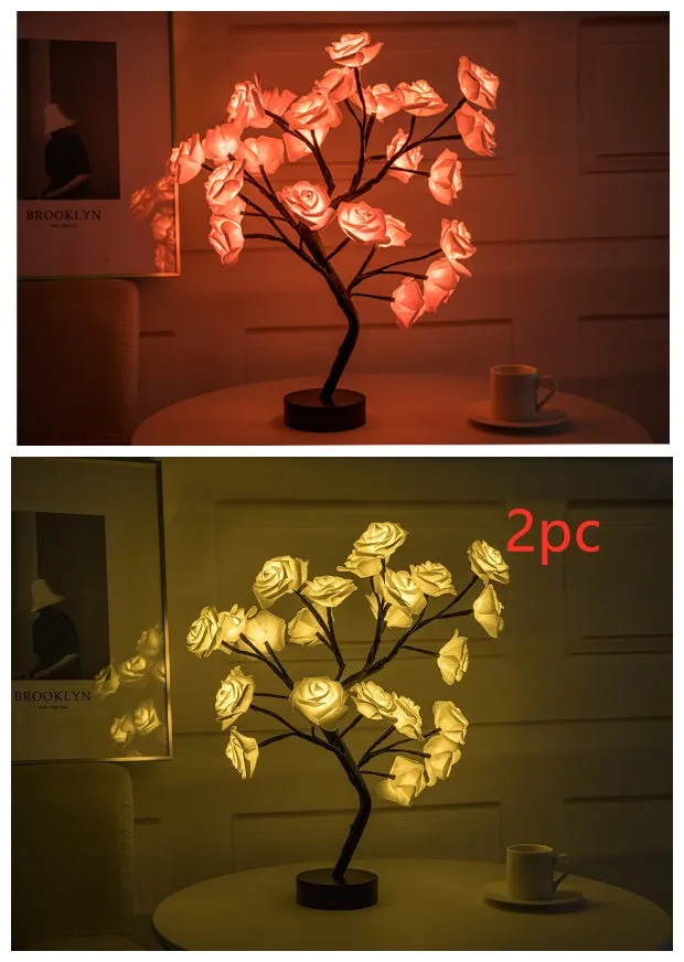 White and red rose flower shaped USB battery LED table lamp with warm white light on a table.