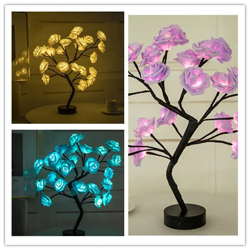 White and red rose flower shaped USB battery LED table lamp with warm white light on a table.