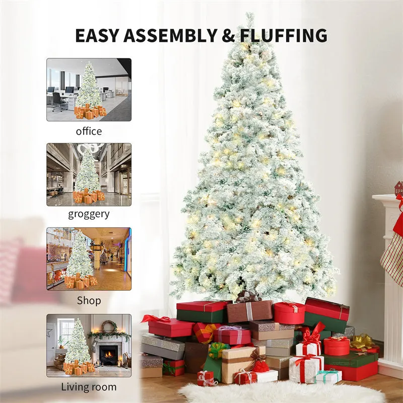 Green and white snow-dusted artificial PVC Christmas tree on a metal stand.