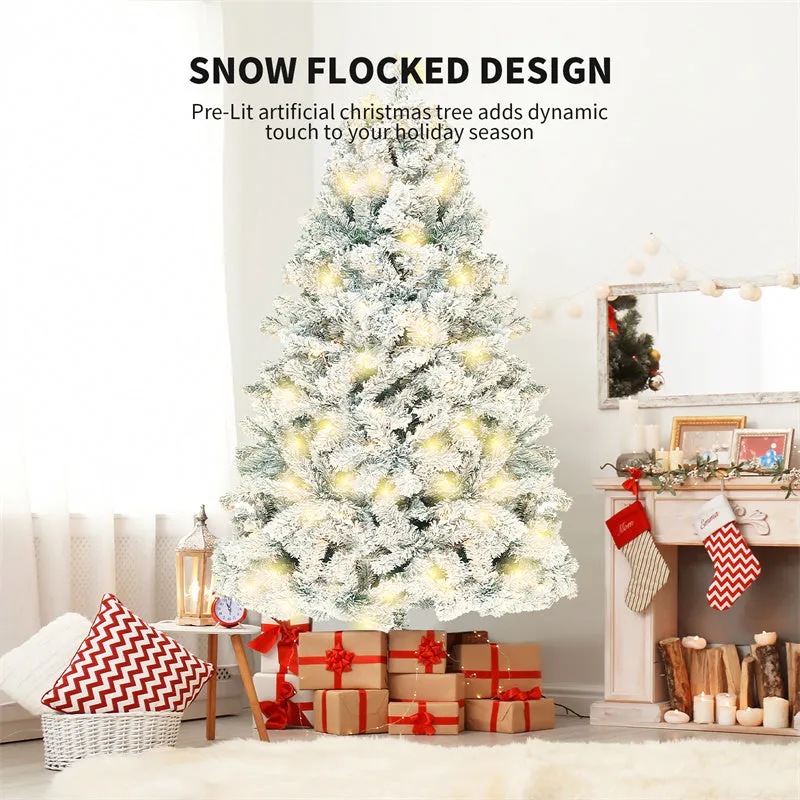 Green and white snow-dusted artificial PVC Christmas tree on a metal stand.