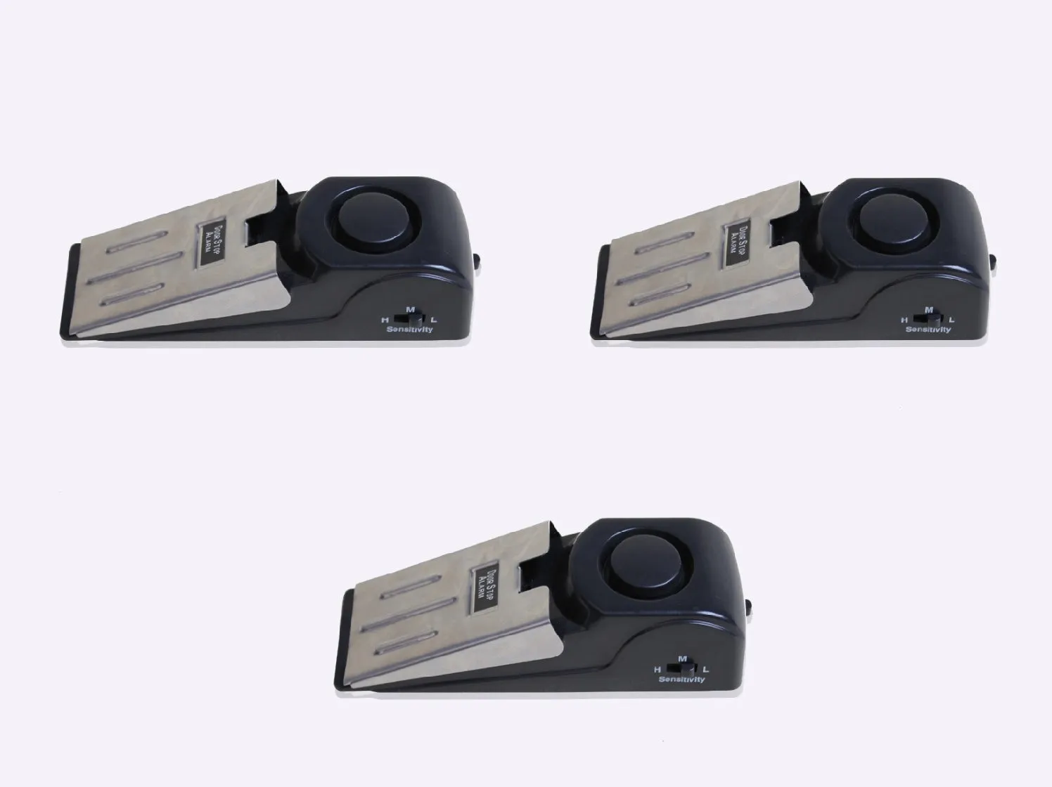 Black portable door stop alarm with wedge shape and stainless steel sensor cover.