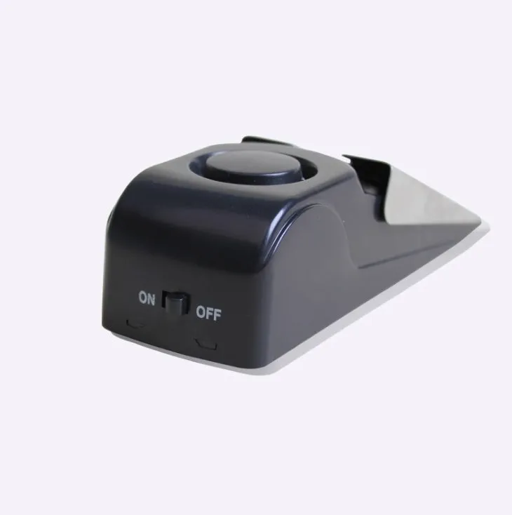 Black portable door stop alarm with wedge shape and stainless steel sensor cover.