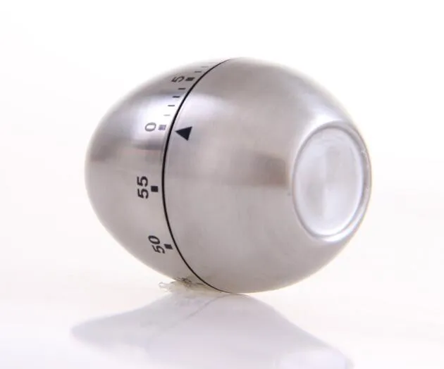 Stainless steel egg-shaped mechanical kitchen timer on a kitchen counter
