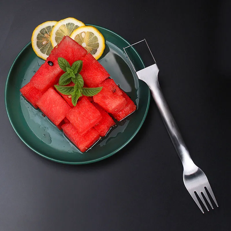 Stainless steel watermelon slicer and fork tool on a kitchen surface