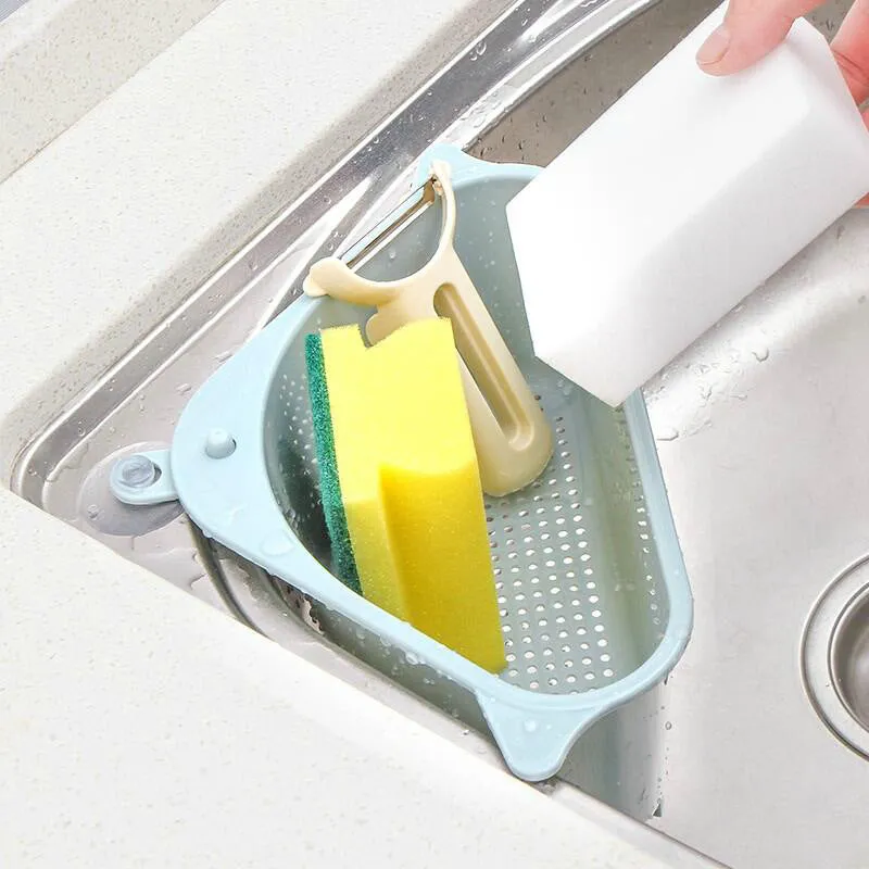 Beige and blue plastic triangle sink storage rack with suction cups holding a sponge