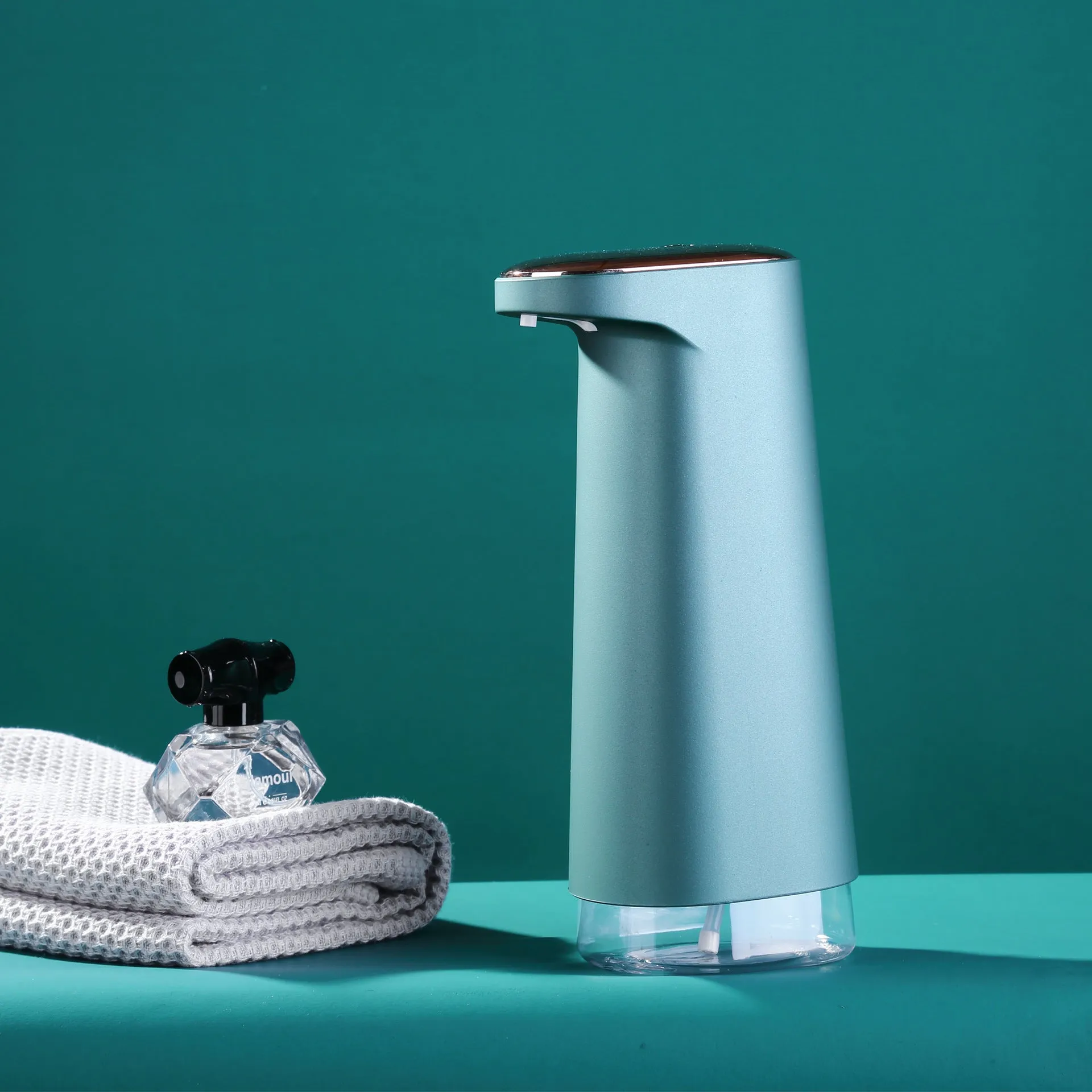 White automatic foam soap dispenser with sensor for touch-free operation on bathroom counter