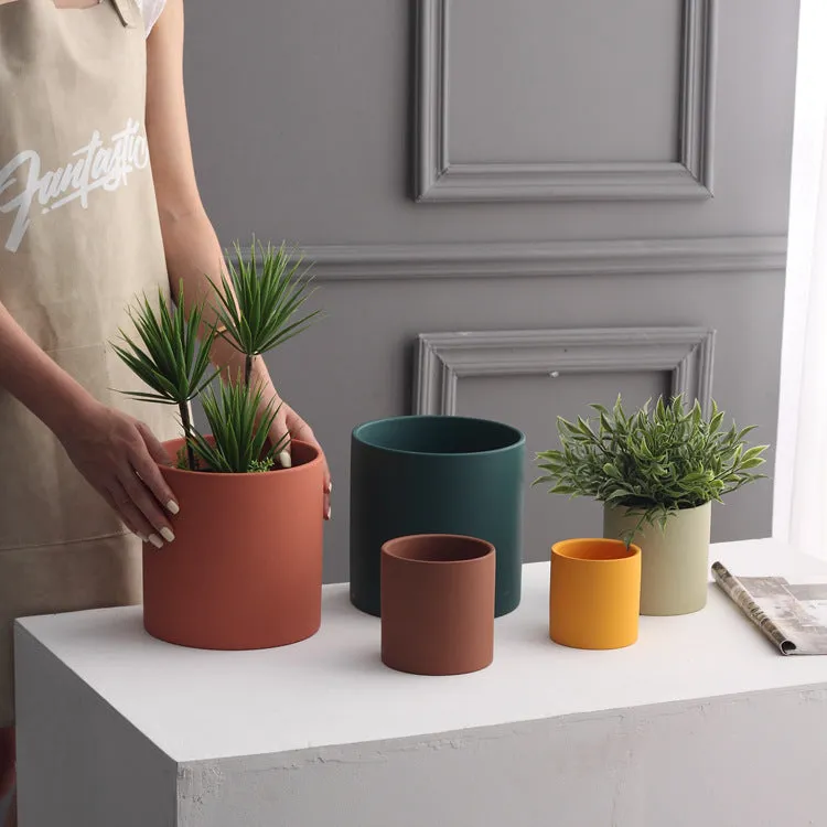 Cylindrical ceramic succulent planter with drainage hole in Nordic style, shown in a selected colour.