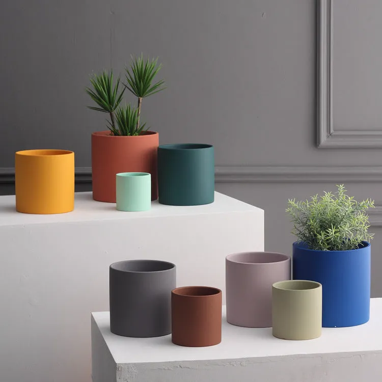 Cylindrical ceramic succulent planter with drainage hole in Nordic style, shown in a selected colour.