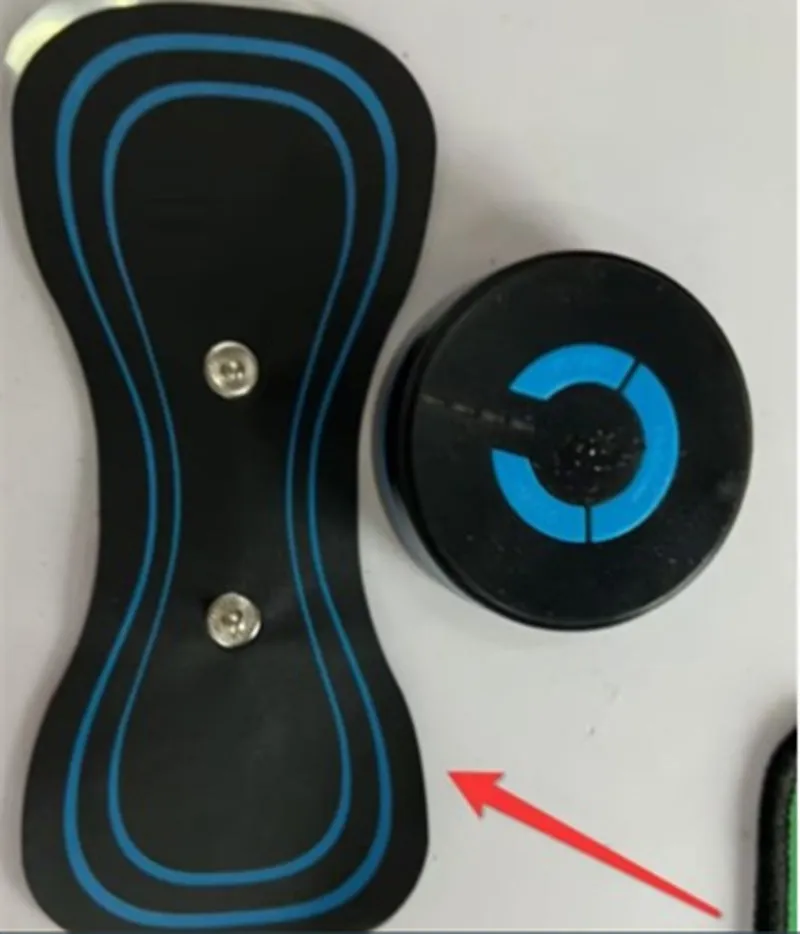 Black HQ-185 mini electric shoulder and neck massager with massage patch, shown next to a ruler for scale.
