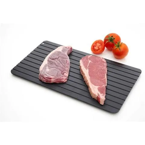 Black aluminium quick defrosting tray for thawing frozen meat and food without electricity.