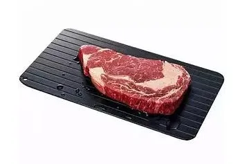Black aluminium quick defrosting tray for thawing frozen meat and food without electricity.