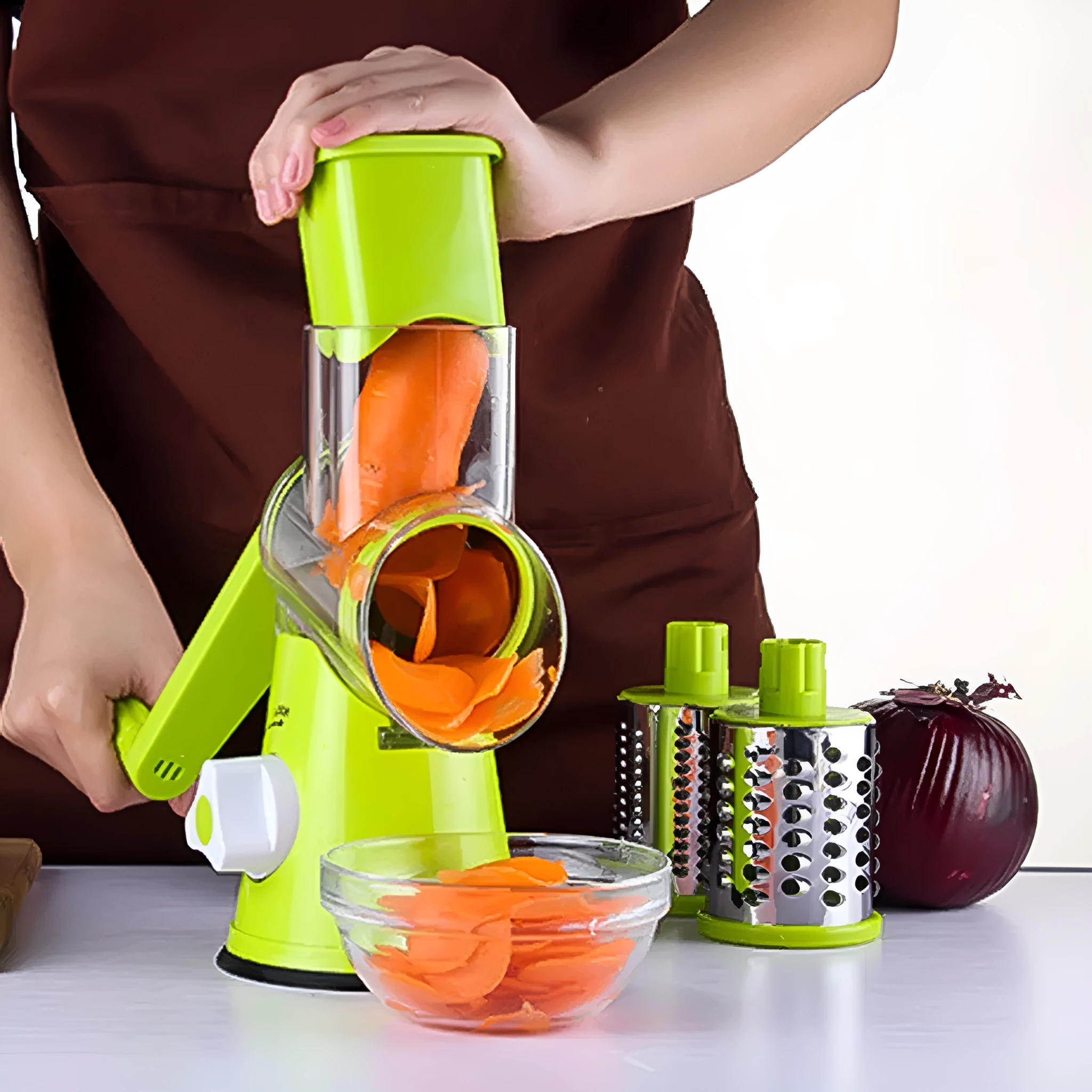 Round vegetable mandoline slicer with stainless steel blades and suction base in green colour