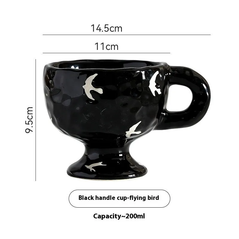 Handmade irregular solid colour ceramic mug on a table, showing its unique shape.