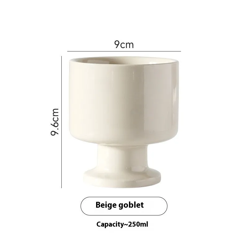 Handmade irregular solid colour ceramic mug on a table, showing its unique shape.