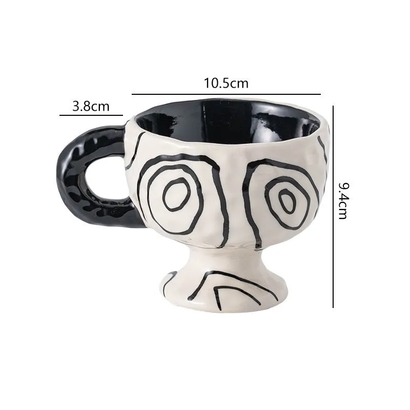 Handmade irregular solid colour ceramic mug on a table, showing its unique shape.