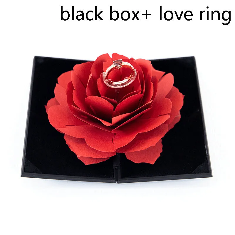 Red plastic heart-shaped rotating ring box with rose decoration inside white storage case