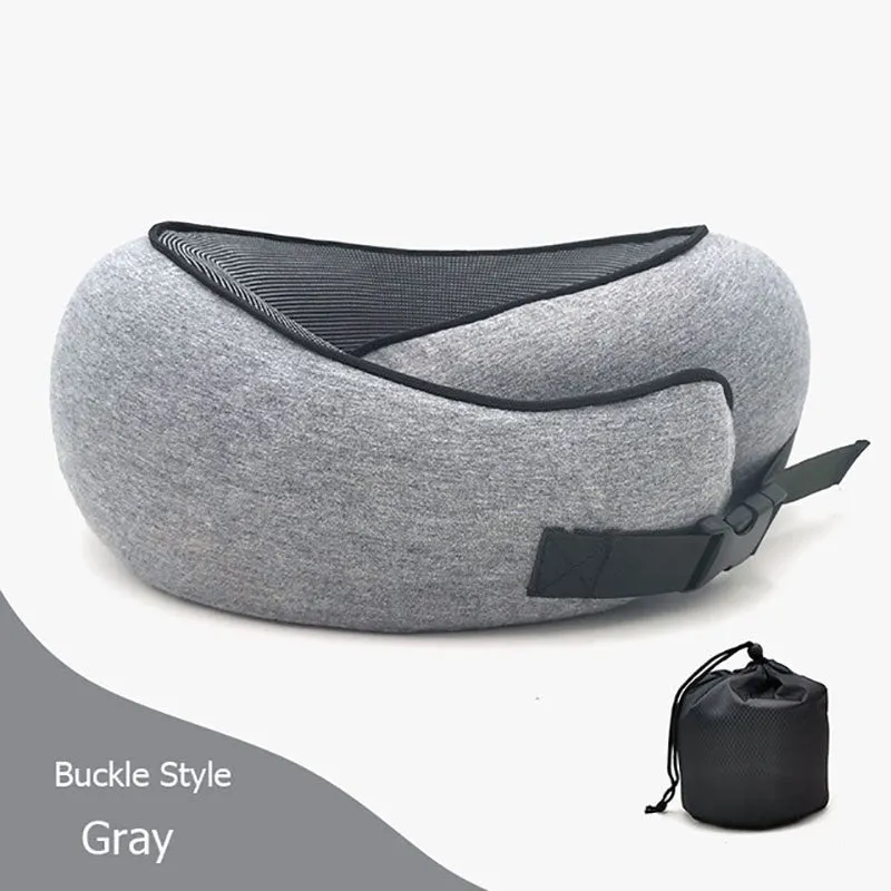 Navy blue U-shaped memory foam travel neck pillow rolled up next to its carry bag.