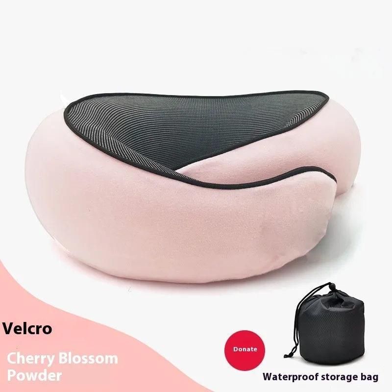 Navy blue U-shaped memory foam travel neck pillow rolled up next to its carry bag.