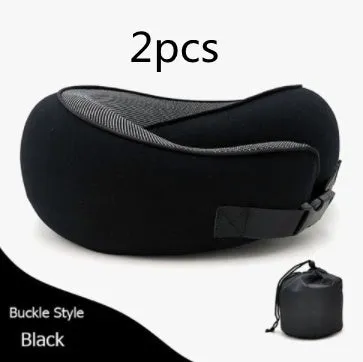 Navy blue U-shaped memory foam travel neck pillow rolled up next to its carry bag.